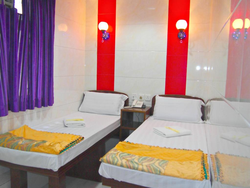 Katil atau katil-katil dalam bilik di Traveller's Hostel