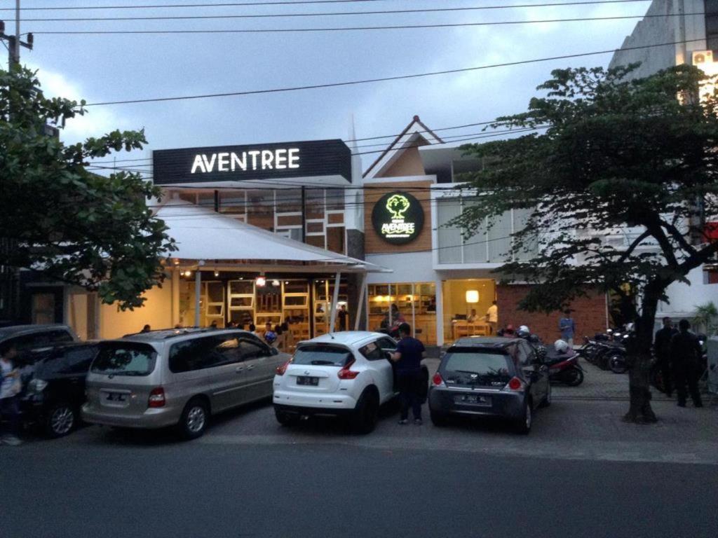 a group of cars parked in front of a store at Aventree Homestay in Malang