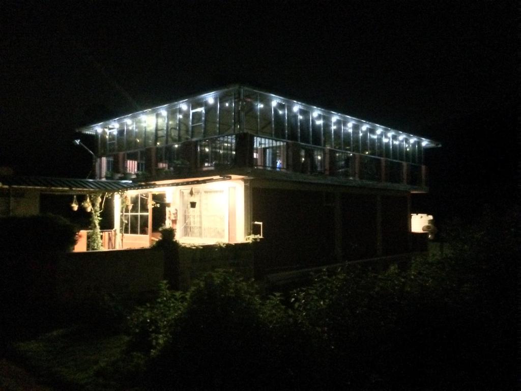 a lit up house with lights on it at night at Mountside Cottages in Ooty