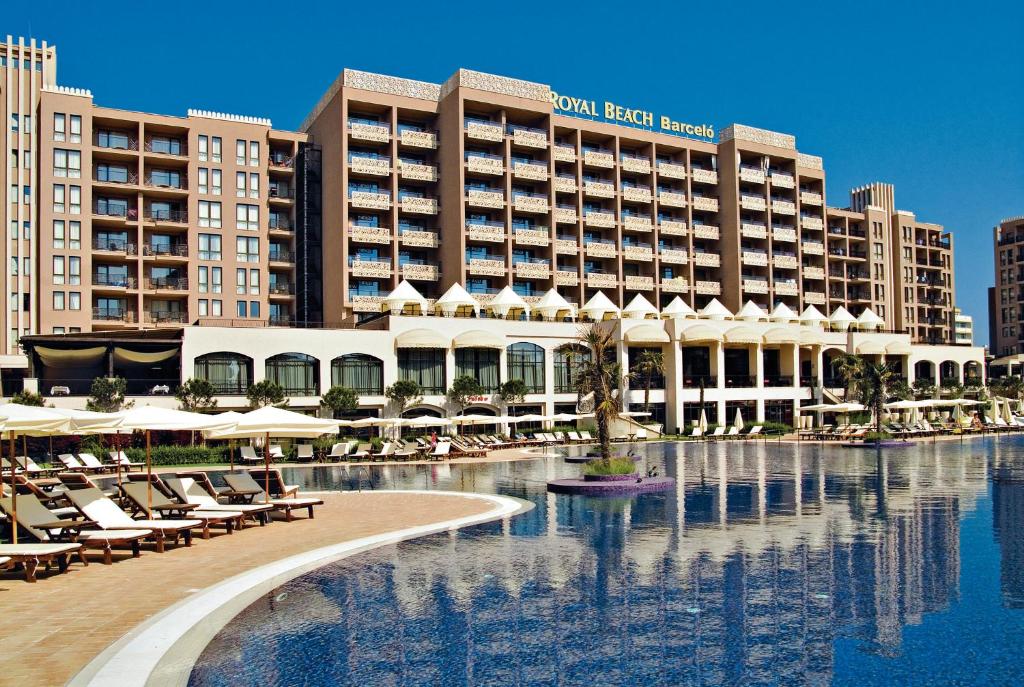 a hotel with a swimming pool in front of a resort at Private Apartments in Royal Beach 5* in Sunny Beach