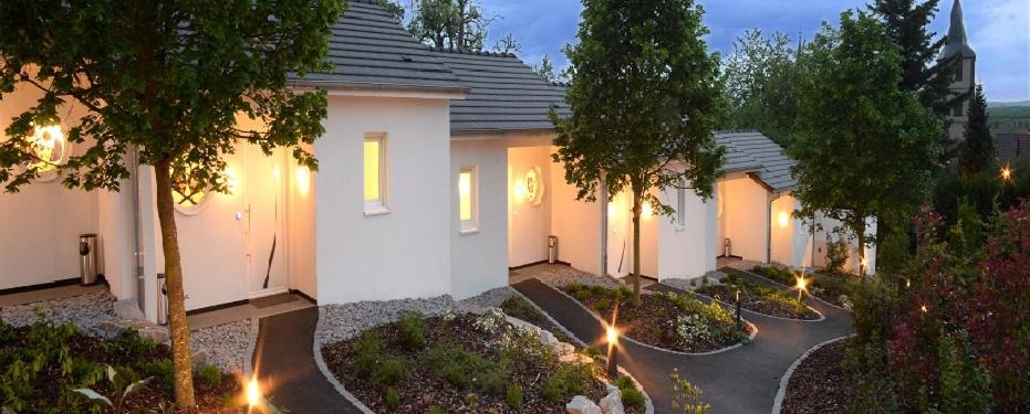 a row of houses with lights in a yard at Mini-suites Le Rêve in Kirrwiller
