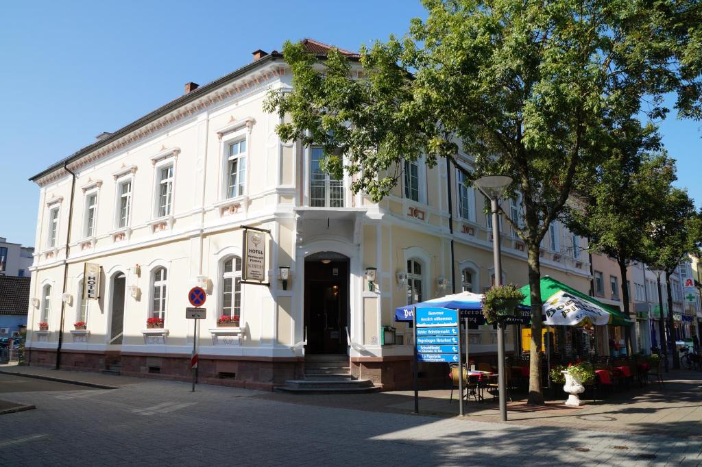 a white building on the side of a street at Hotel Restaurant Schwert in Kehl am Rhein