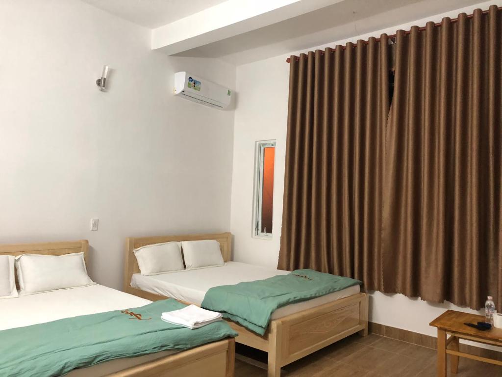 Postel nebo postele na pokoji v ubytování An Ngọc Linh Hotel