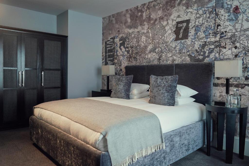 
a large bed in a bedroom with a large window at Malmaison Liverpool in Liverpool
