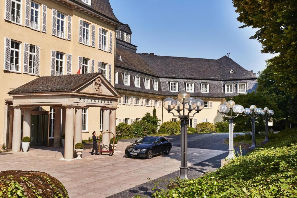 a car parked in front of a building with a gazebo at Steigenberger Grandhotel & Spa Petersberg in Königswinter