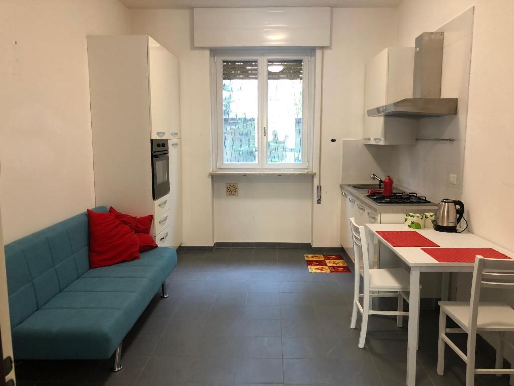 een woonkamer met een blauwe bank in een keuken bij Senza pensieri Piazza Marconi in Crema
