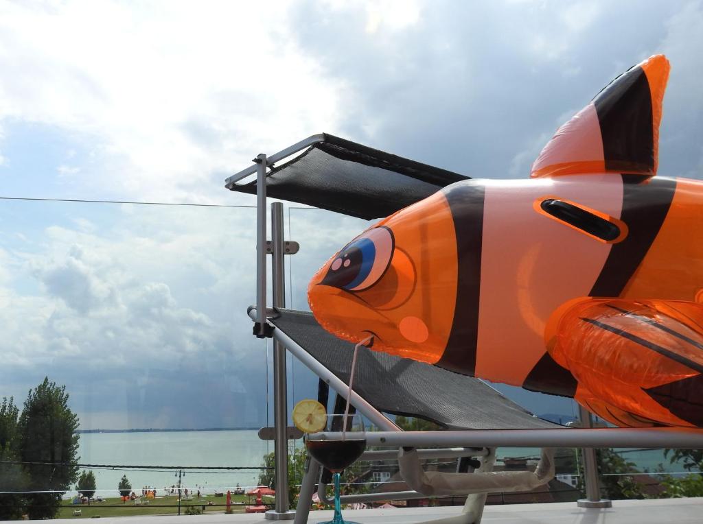 an orange and black plane is sitting on display at Blue Beach Panorama in Révfülöp