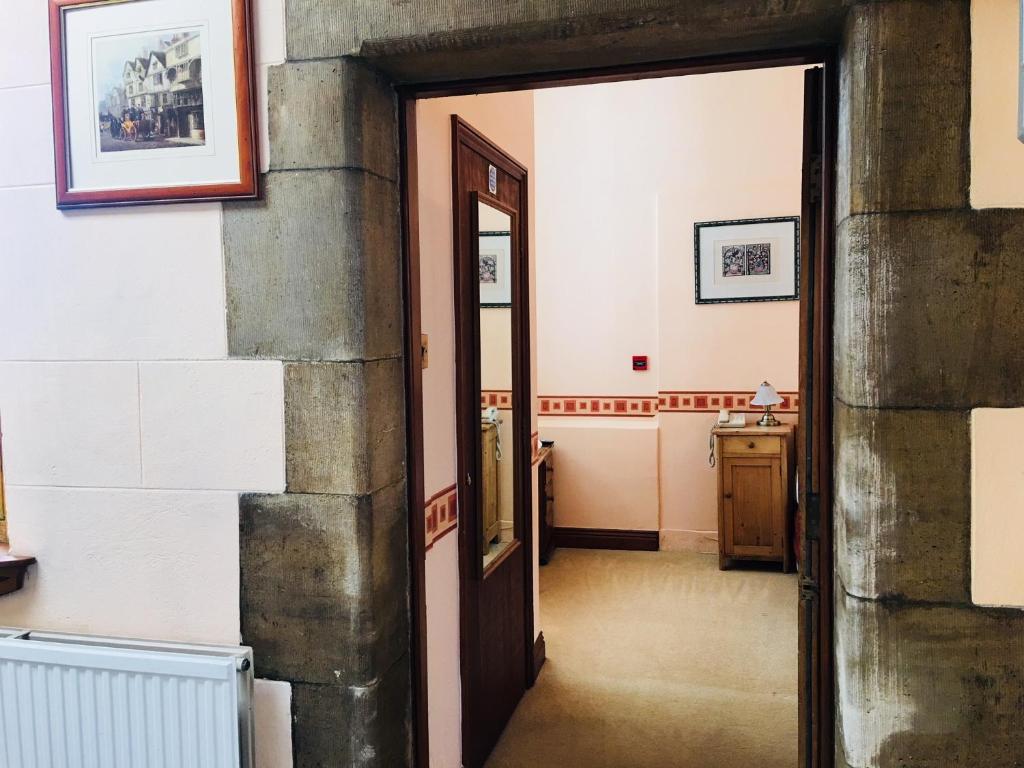 an open door into a hallway in a building at Purbeck House Hotel & Louisa Lodge in Swanage