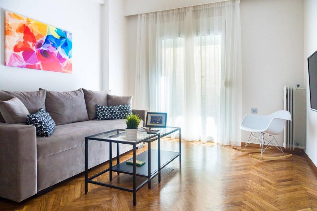 a living room with a couch and a table at TONI'S Classy Home in Kolonaki, local's Gem in Athens