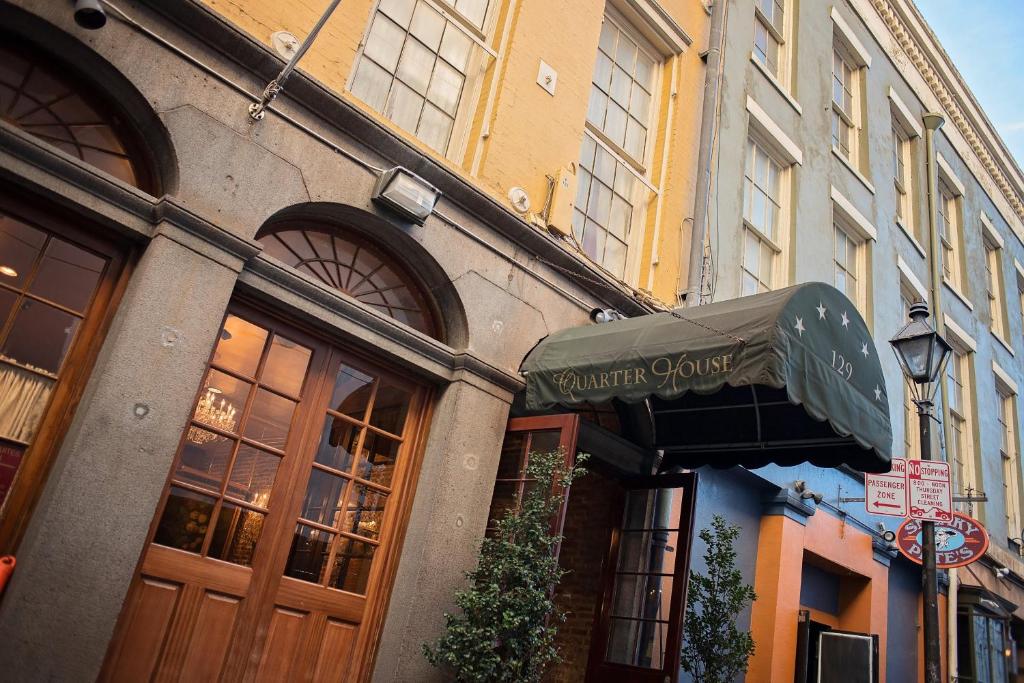 a building with a sign for a garden cafe at Quarter House in New Orleans