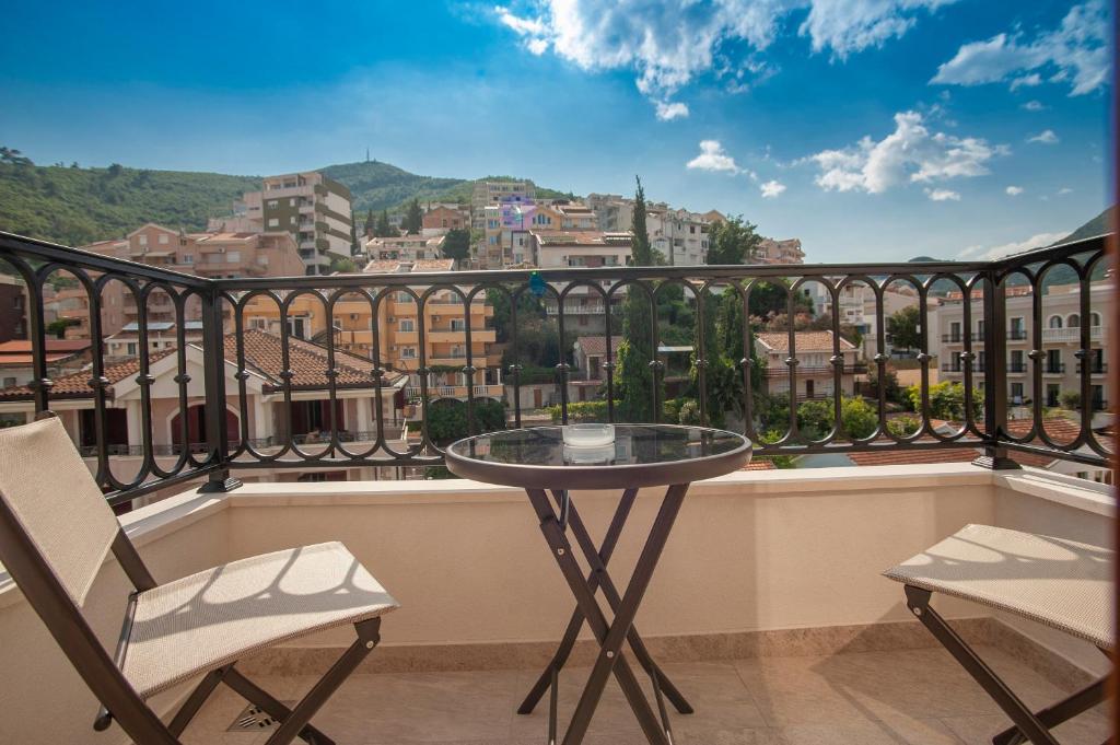 a table and two chairs on a balcony with a view at Hotel Villa Gracia in Budva