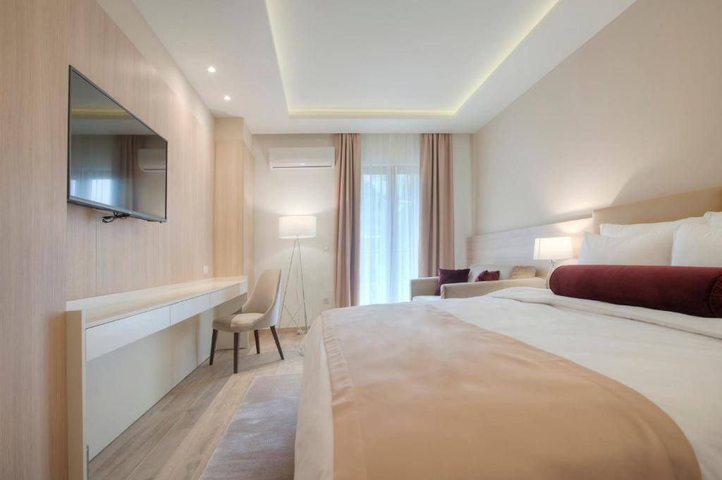 a hotel room with a bed and a television at Hotel Villa Gracia in Budva