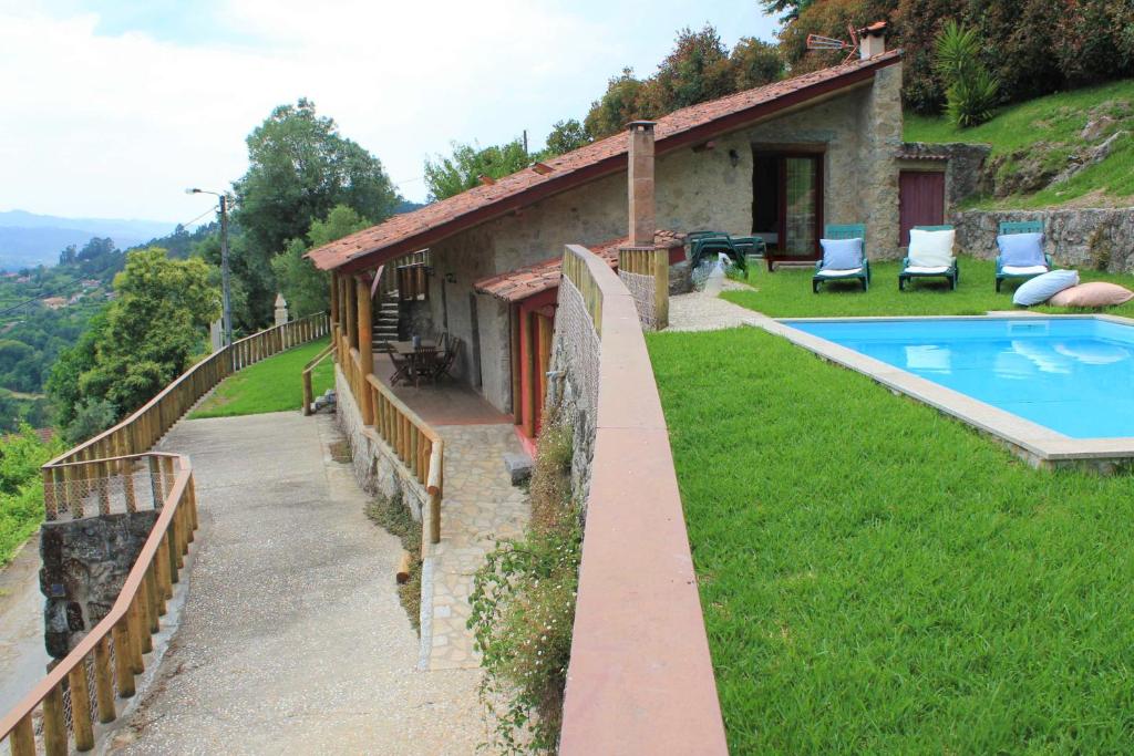 a house on a hill with a swimming pool at Casa do Caminho do Monte in Arcos de Valdevez