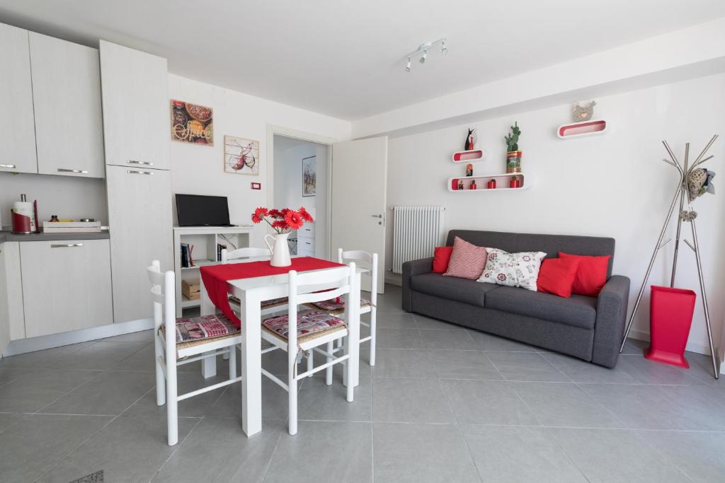 a living room with a table and a couch at Ca d'Ada in Tolmezzo