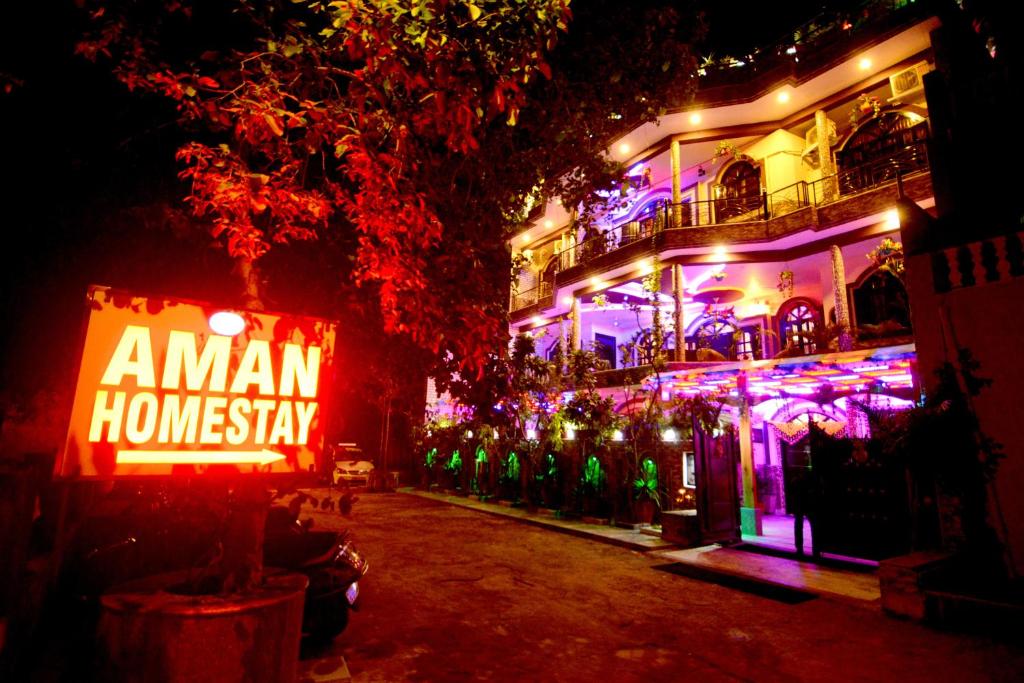 a building with a sign that says amanh homasy at night at Aman Homestay, A Boutique Hotel in Agra