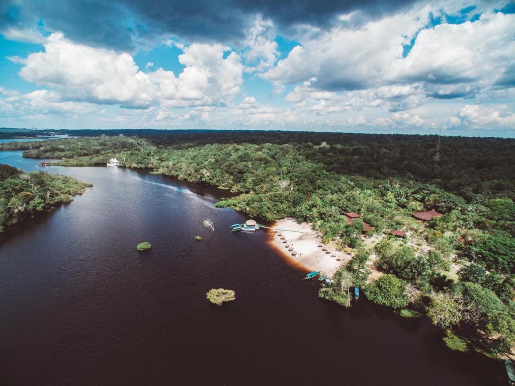 an aerial view of a river with a beach at Amazon Ecopark Jungle Lodge in Manaus