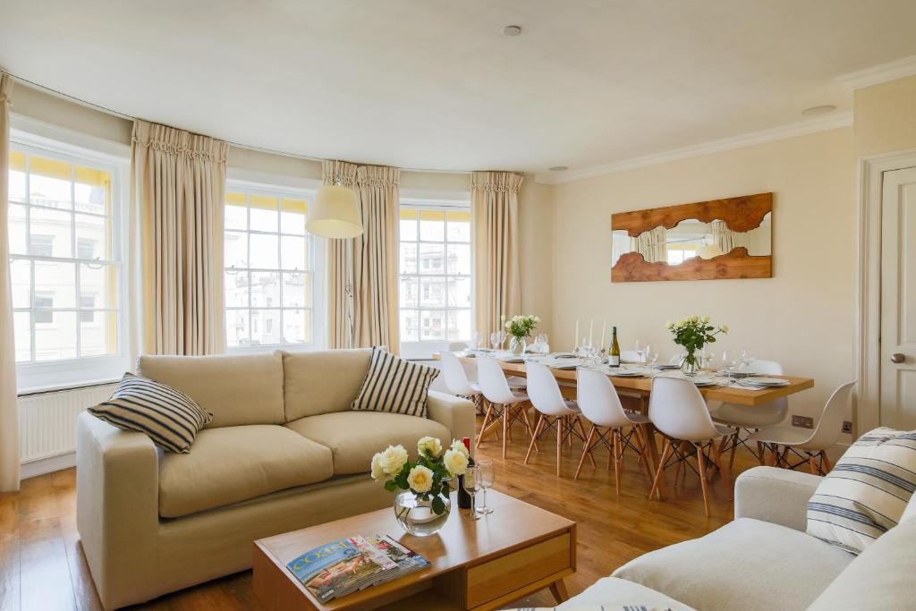 a living room with a couch and a table at Sea View Penthouse Maisonette in Brighton & Hove