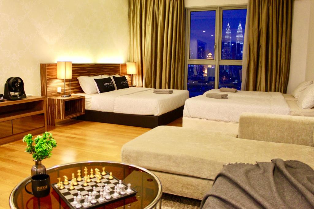 a hotel room with two beds and a chess board at T1 KLCC view Studio@Regalia Infinity Pool in Kuala Lumpur