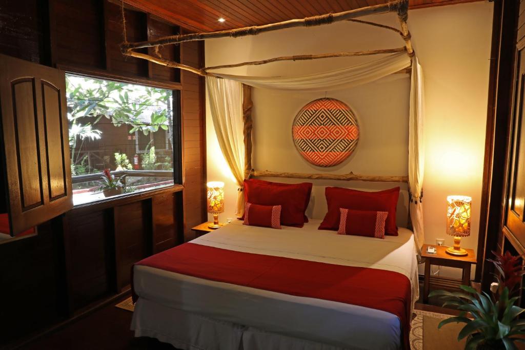 Postel nebo postele na pokoji v ubytování Amazon Ecopark Jungle Lodge
