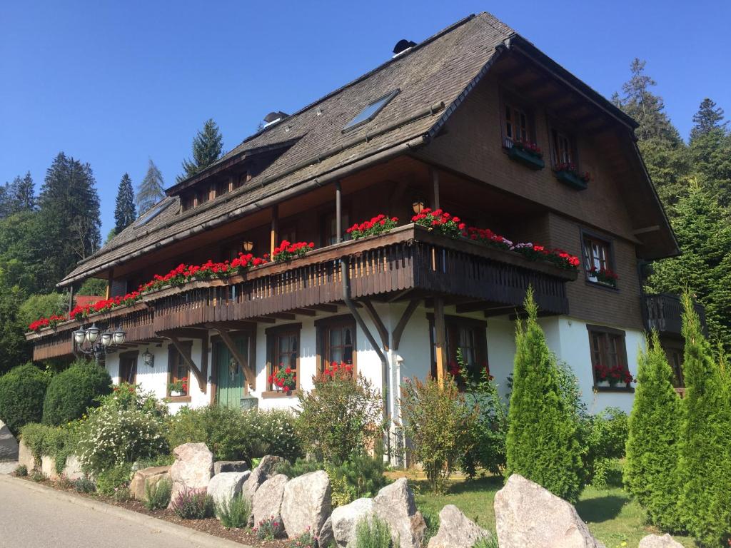 a house with flowers on the side of it at Hollhouse - Bed & Breakfast in Hinterzarten