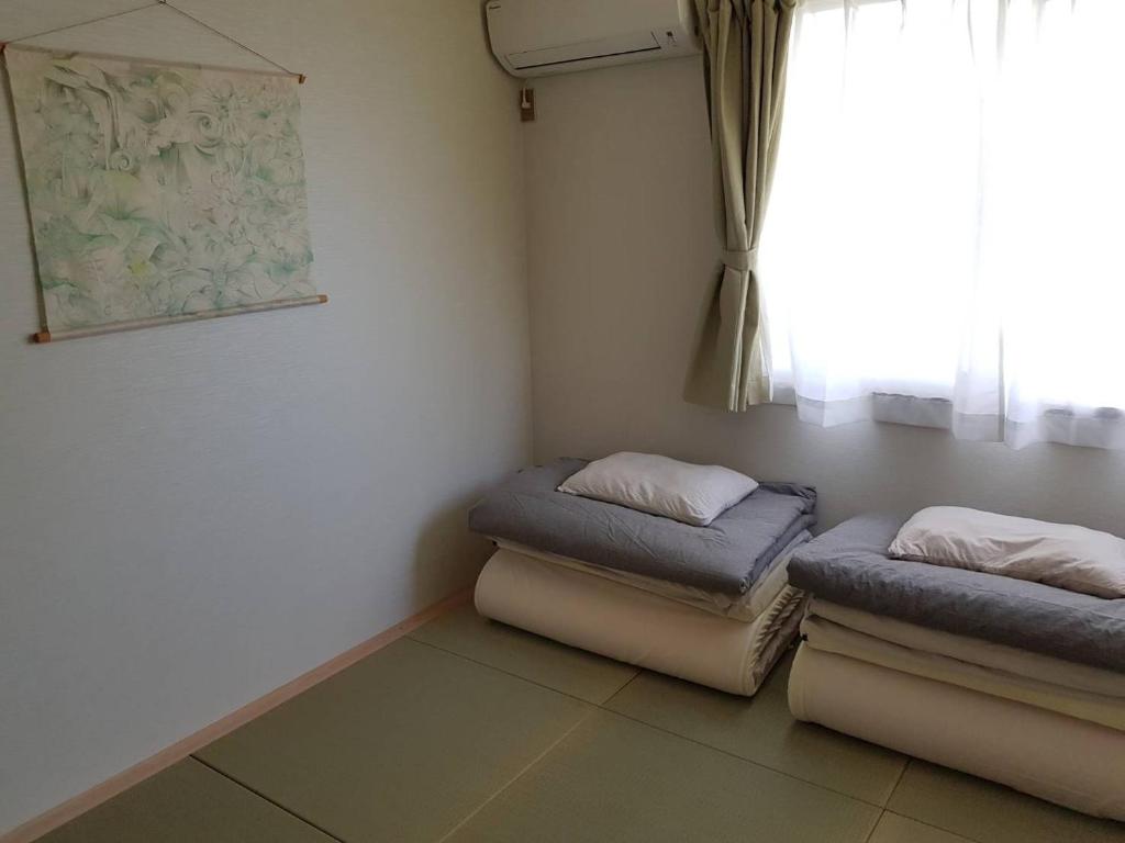 Postel nebo postele na pokoji v ubytování Sen Guesthouse