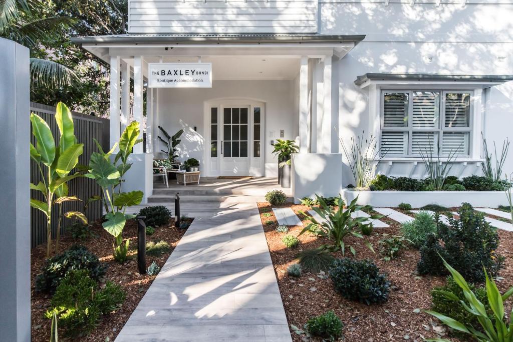 a white house with a pathway leading to the front door at The Baxley Bondi in Sydney