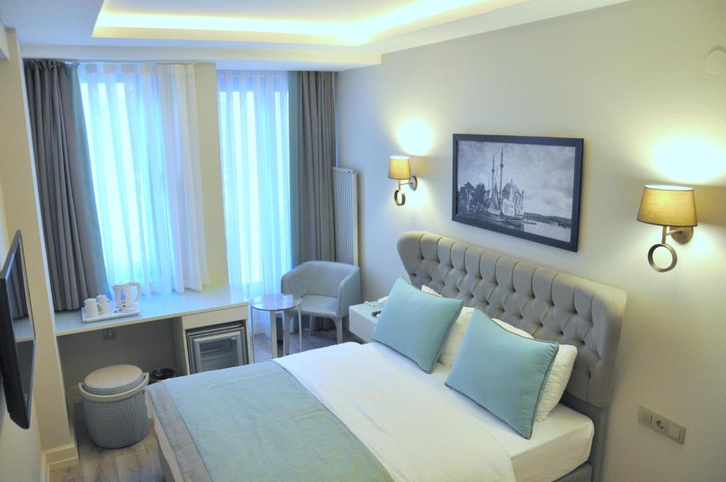 Postel nebo postele na pokoji v ubytování Centrum Suites İstanbul