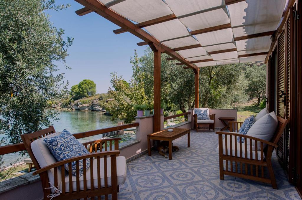 a porch with chairs and a view of a river at Beach House Onar in Diaporos