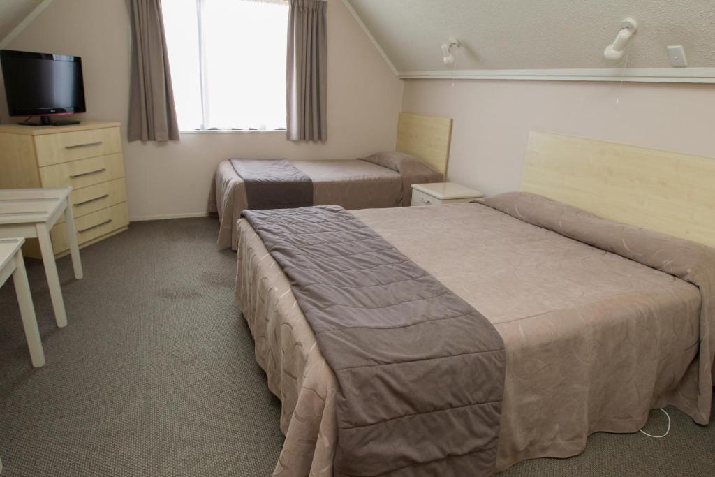 Postel nebo postele na pokoji v ubytování Aspen Manor Motel