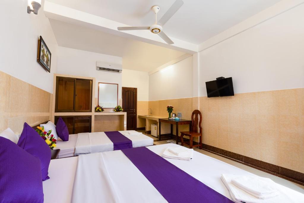 Ένα ή περισσότερα κρεβάτια σε δωμάτιο στο Botoum Hostel