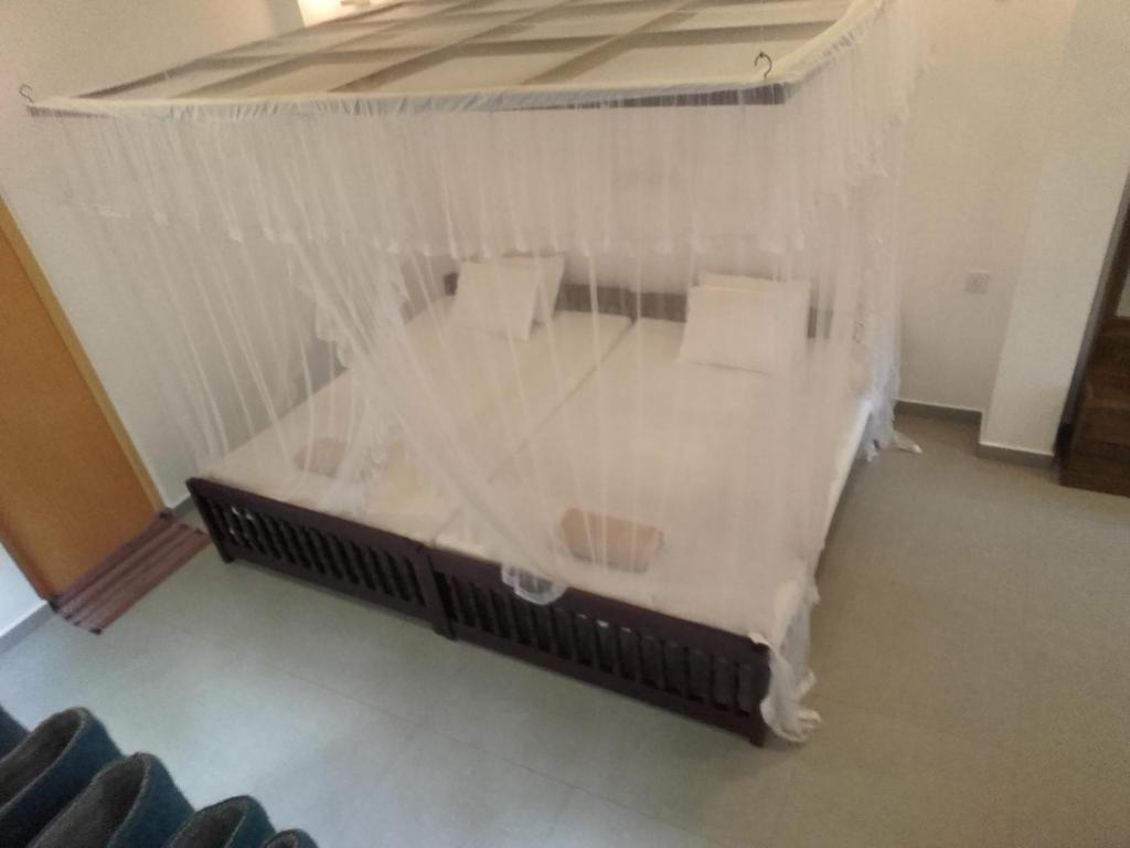 Postel nebo postele na pokoji v ubytování Thusara Guesthouse
