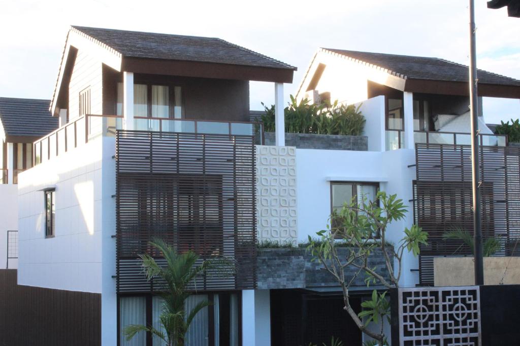 a house with black balconies on top of it at Kuta Ardenia Residence in Kuta