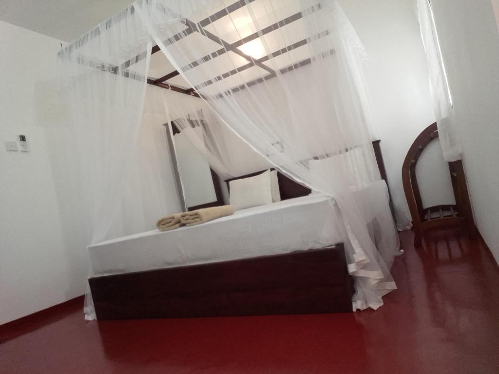 Postel nebo postele na pokoji v ubytování Thusara Guesthouse
