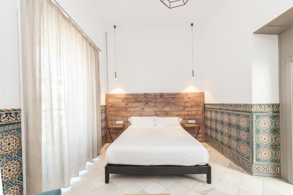 Postel nebo postele na pokoji v ubytování Apartahotel Siglo XIX