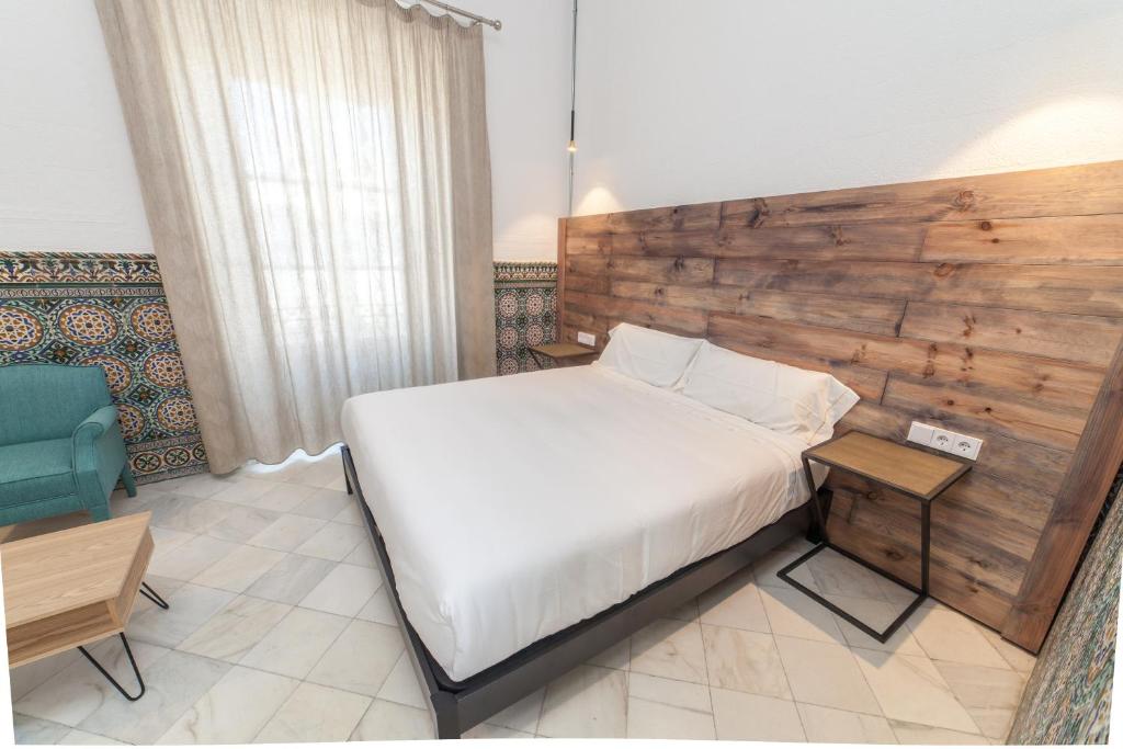 Postel nebo postele na pokoji v ubytování Apartahotel Siglo XIX