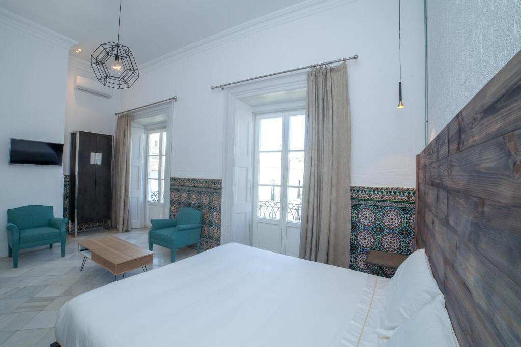 Postel nebo postele na pokoji v ubytování Apartahotel Siglo XIX