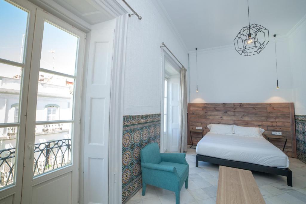 Postel nebo postele na pokoji v ubytování Apartahotel Siglo XIX