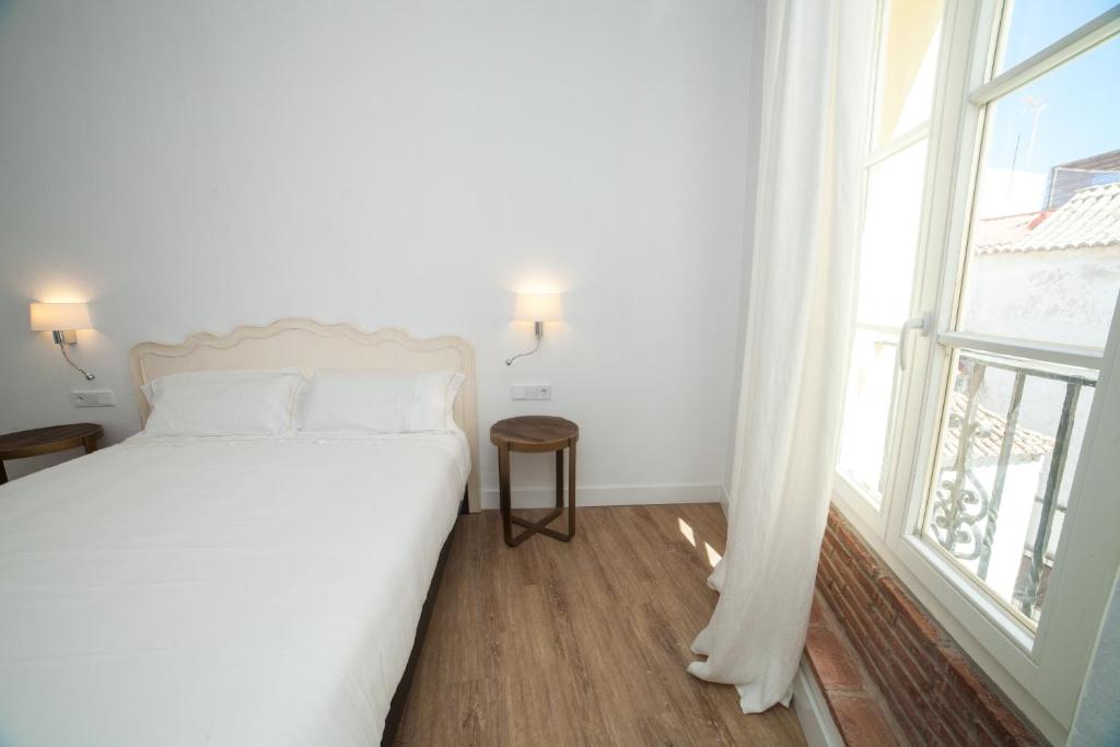 Postel nebo postele na pokoji v ubytování Apartahotel Siglo XIX