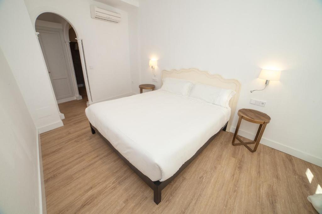 Postel nebo postele na pokoji v ubytování Apartahotel Siglo XIX