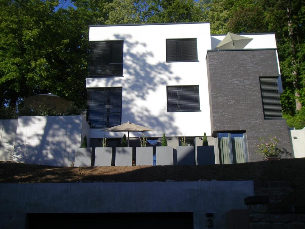 a white building with an umbrella in front of it at Studio3 in Eisenach