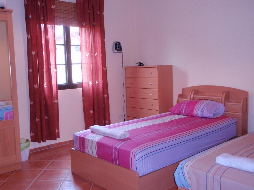 a bedroom with two beds and a dresser in it at Seabreeze 145 by malai in Rayong