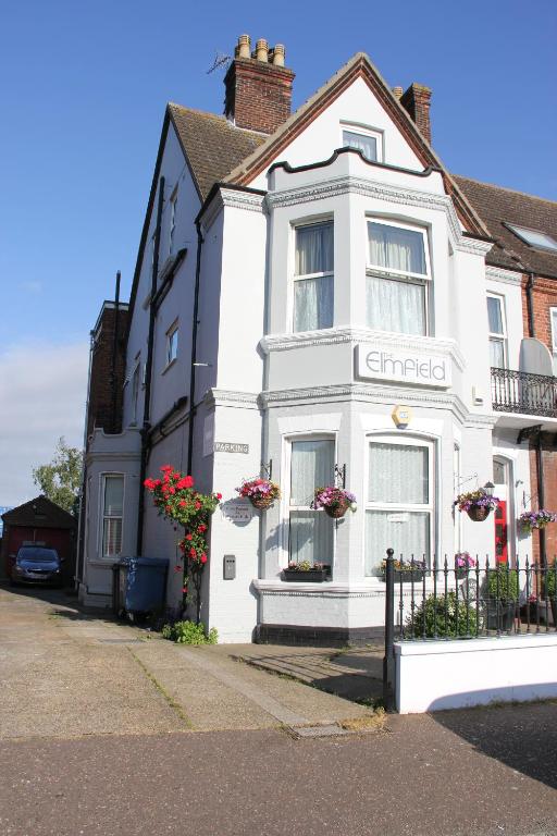 a white building with flowers in the window at The Elmfield in Great Yarmouth