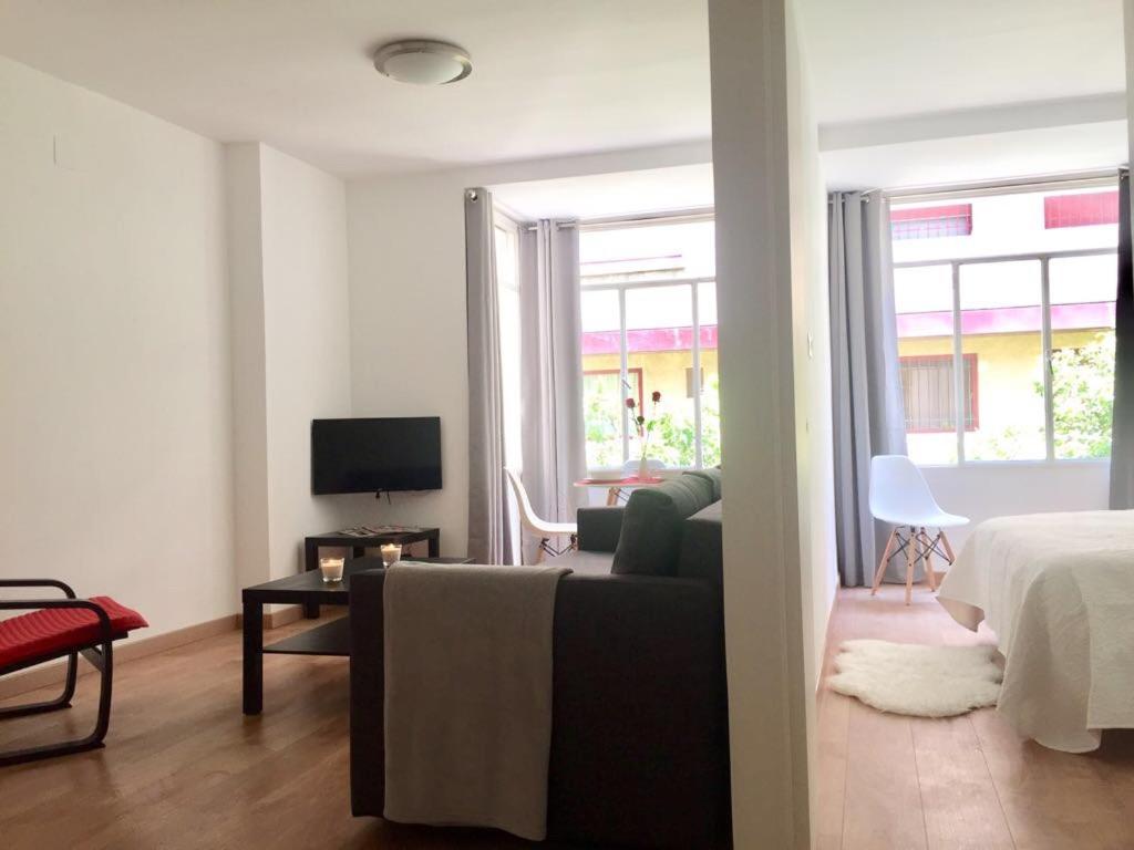 a living room with a couch and a bed and a television at Gandia Centro VT-44718-V in Gandía