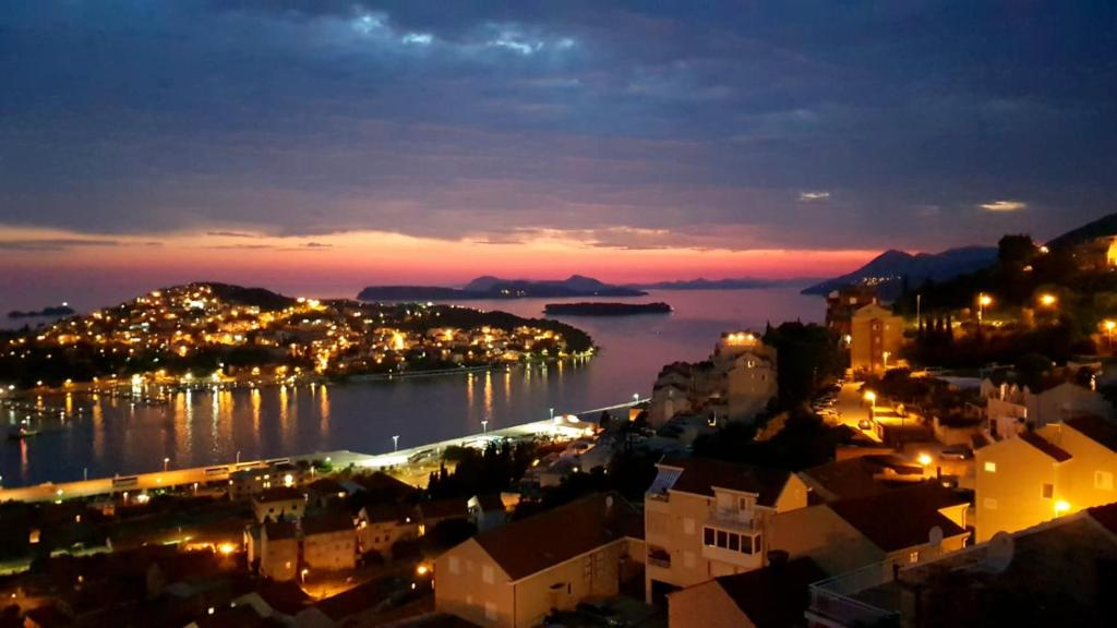 a view of a city at night with a harbor at Rooms Tomaš in Dubrovnik