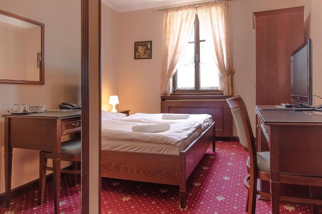 Postel nebo postele na pokoji v ubytování Hotel Buchlovice