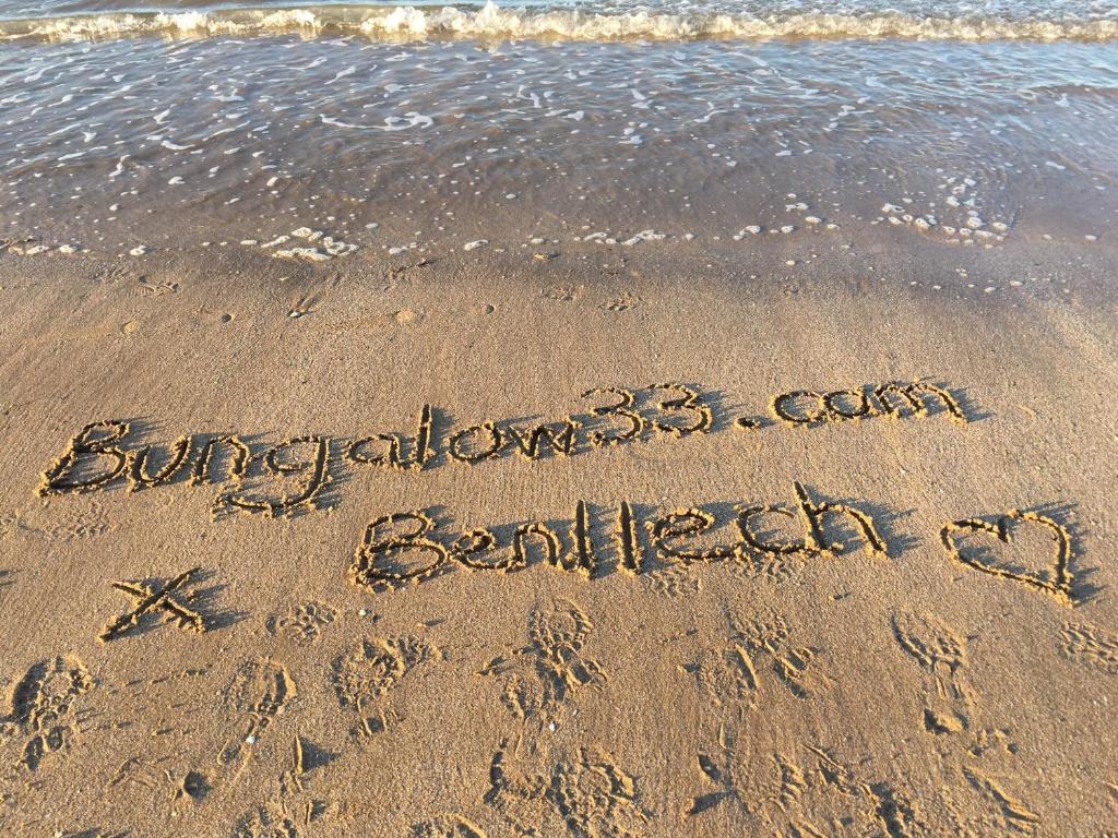 a message written in the sand on the beach at Bungalow33 Benllech in Benllech