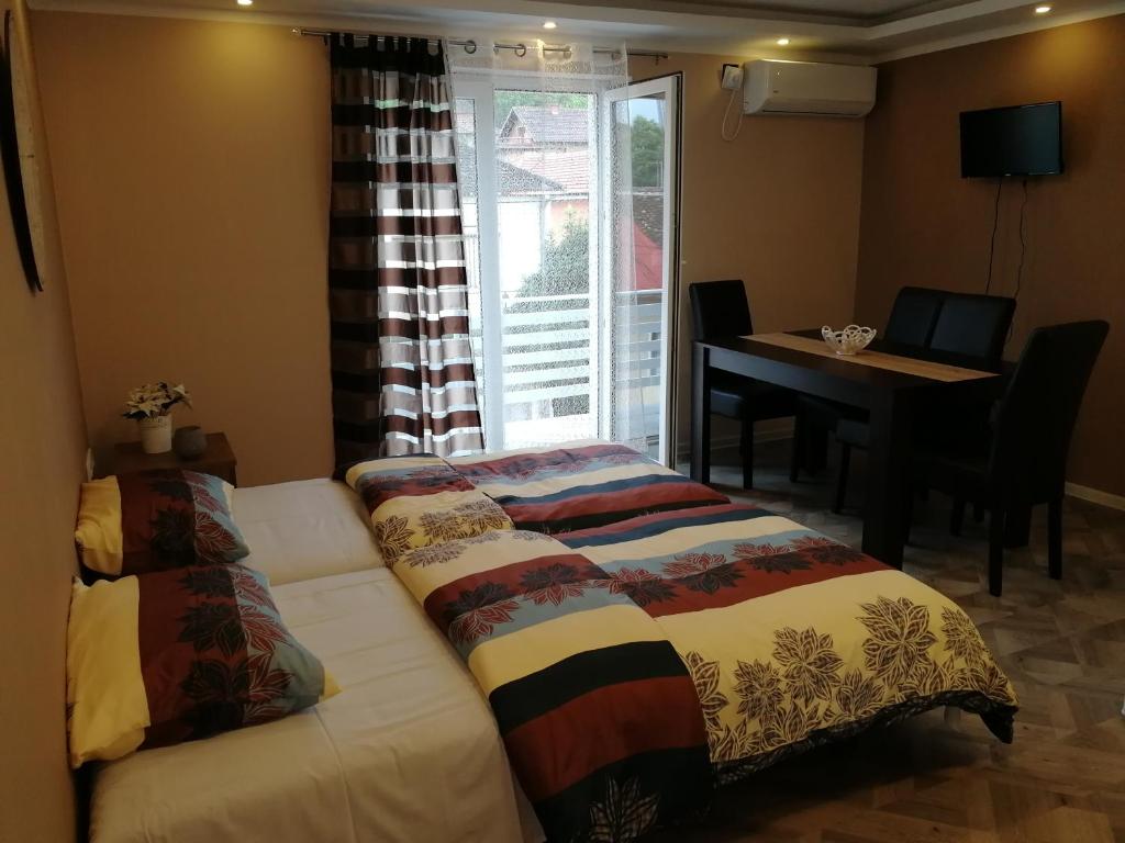 Postel nebo postele na pokoji v ubytování Apartman Bogić