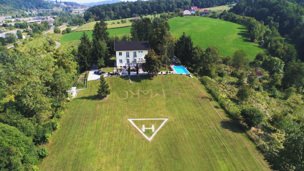 an aerial view of a house on a field with a v sign on it at Karavla Private Villa in Šentilj