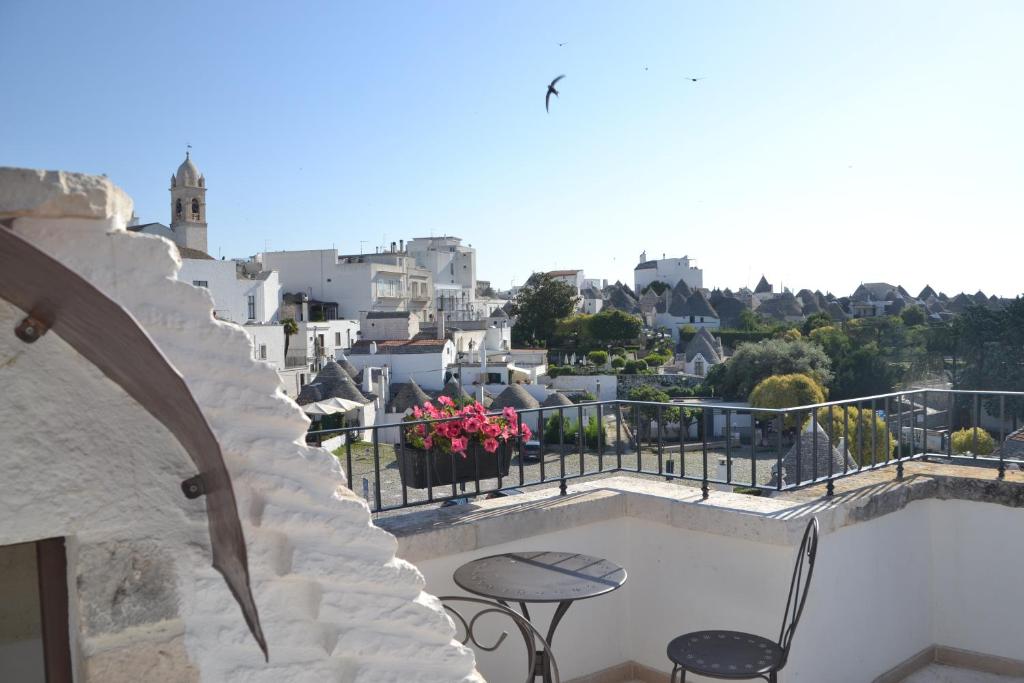 a balcony with tables and a view of a city at Terrazza Sui Trulli in Alberobello