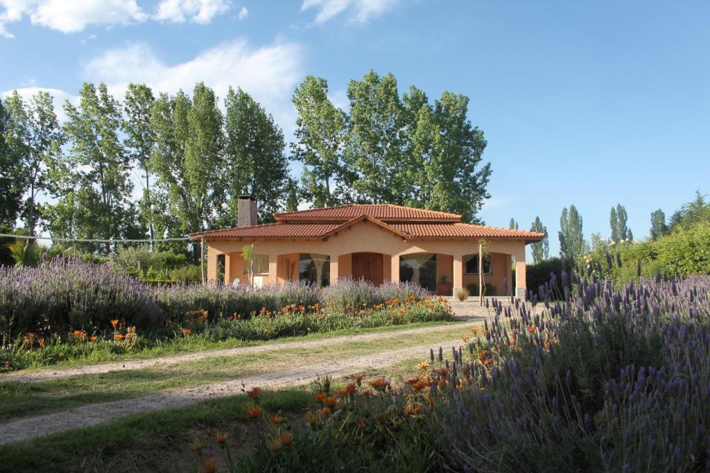 una casa en medio de un jardín con flores en Casona Aventurados en Luján de Cuyo